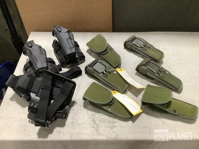 (14) Pistol Holsters, (8) Flashlight Mounts & Assorted Items