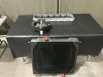 (1) Radiator, (1) Engine Cover, (2) Brake Spiders & Assorted Items