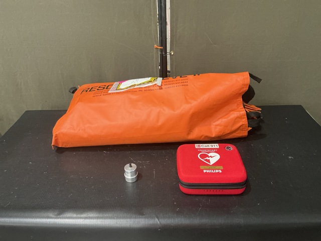 (1) Defibrillator, (1) Litter Splint & Assorted Items