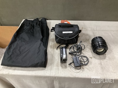(1) Camera Lens, (2) Video Cameras, (7) Pairs of Pants & Assorted Items