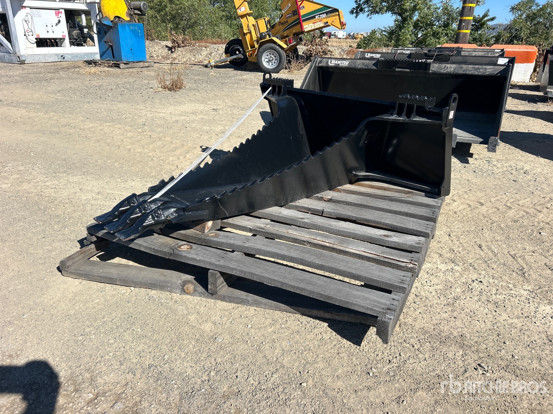 Cat 44 in Skid Steer Stump Bucket