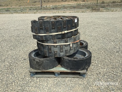 Quantity of (2) skid steer Rubber tracks that go over the tires for Bobcat and 4 solid skid steer Bobcat Tires on rims in Good shape Cadenas - Fits Bobcat